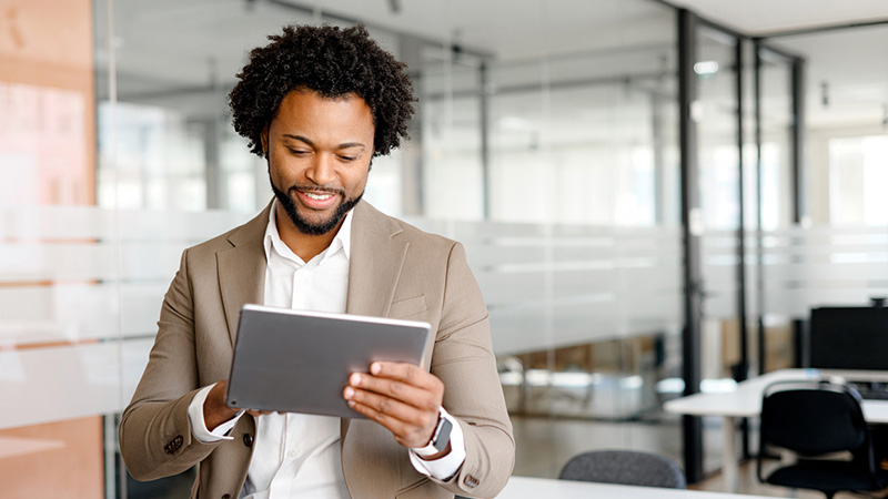 man holding a tablet in an office room