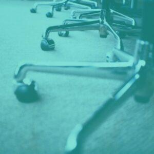 A row of office chairs on a carpeted floor