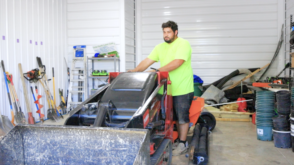 Solar Earth Lawn Care employee using a rental warehouse