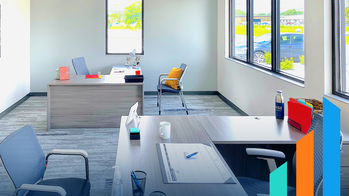 desks and chairs set up in a RISE Commercial District office space rental